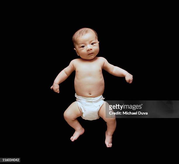 studio shot of baby in diaper on black background - japanese baby photos et images de collection