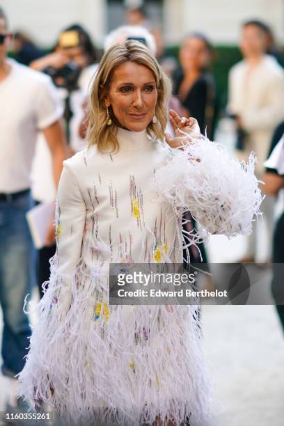Celine Dion wears a white fluffy dress with turtleneck, outside Valentino, during Paris Fashion Week -Haute Couture Fall/Winter 2019/2020, on July...