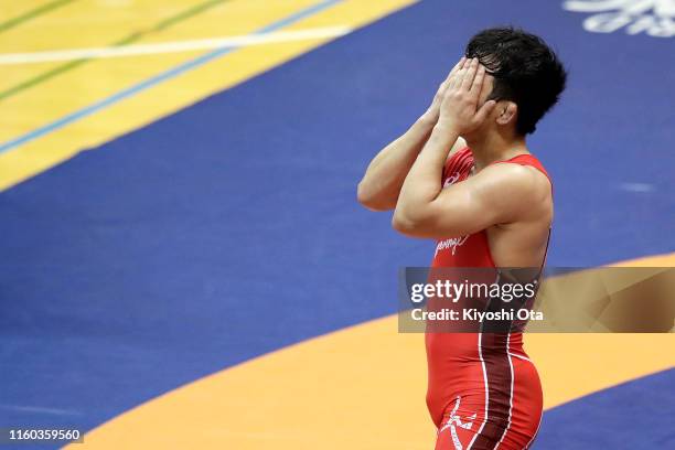 Yuhi Fujinami shows dejection after losing the Men's Freestyle 74kg play-off match against Mao Okui during the Wrestling World Championships Japan...