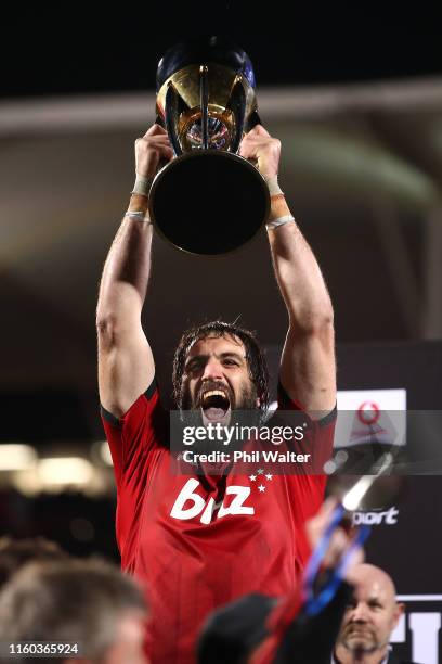 Sam Whitelock of the Crusaders holds up the Super Rugby Trophy following the Super Rugby Final between the Crusaders and the Jaguares at Orangetheory...