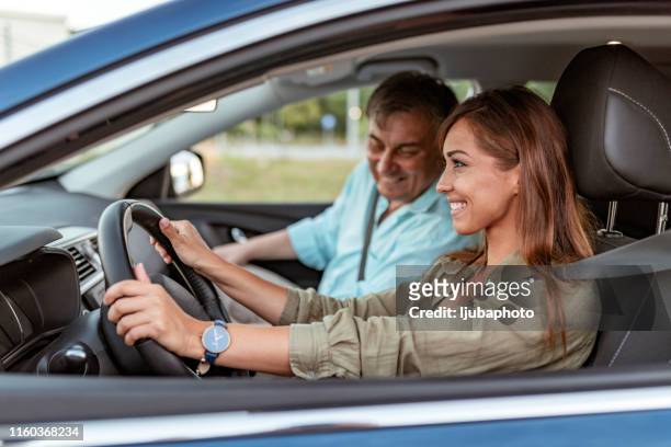 photo of a female learning to drive with her instructor - driving instructor stock pictures, royalty-free photos & images
