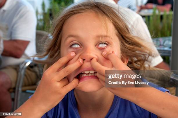 young girl pulling a face - young contortionist stockfoto's en -beelden