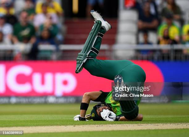 Aiden Markram of South Africa hits the ground to avoid a straight drive from Quinton de Kock of South Africa during the Group Stage match of the ICC...