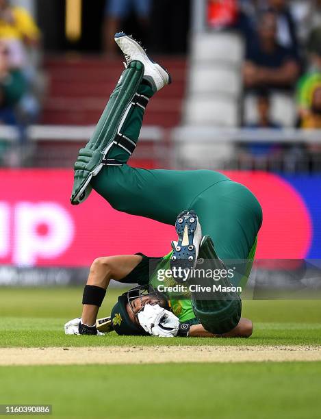 Aiden Markram of South Africa hits the ground to avoid a straight drive from Quinton de Kock of South Africa during the Group Stage match of the ICC...