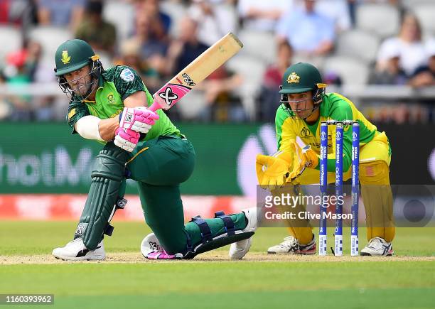 Faf du Plessis of South Africa in action batting as Alex Carey of Australia looks on during the Group Stage match of the ICC Cricket World Cup 2019...