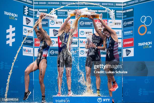 Cassandre Beaugrand of France, Non Stanford of Great Britain , Katie Zaferes of USA and and Summer Rappaport of USA play with beer on the podium...