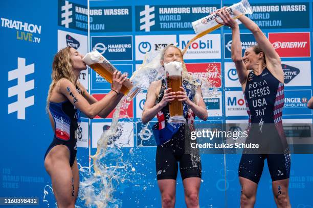 Cassandre Beaugrand of France, Non Stanford of Great Britain and Katie Zaferes of USA play with beer on the podium after the ITU World Triathlon...