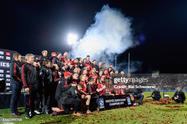 Captain Samuel Whitelock of the Crusaders and his team mates celebrate with the Super Rugby trophy after winning the Super Rugby Final between the...