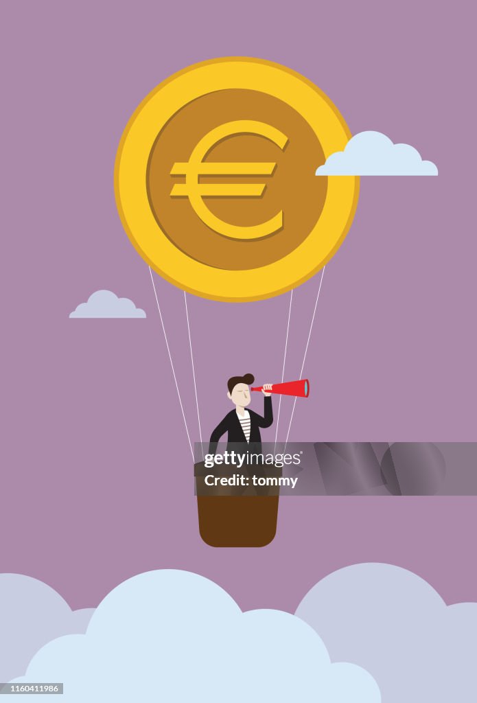 Homme d'affaires sur le ballon de pièce de monnaie d'euro