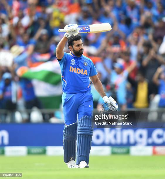 Rohit Sharma of India raises his bat after he scores 100 runs during the Group Stage match of the ICC Cricket World Cup 2019 between Sri Lanka and...