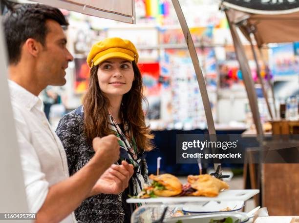 buying food in greenwich market - street food market uk stock pictures, royalty-free photos & images