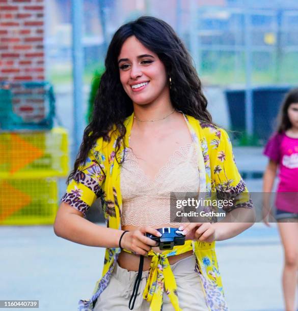 Camila Cabello takes a photo while out with Shawn Mendes on August 8, 2019 in New York City.