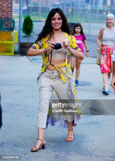 Camila Cabello takes a photo while out with Shawn Mendes on August 8, 2019 in New York City.