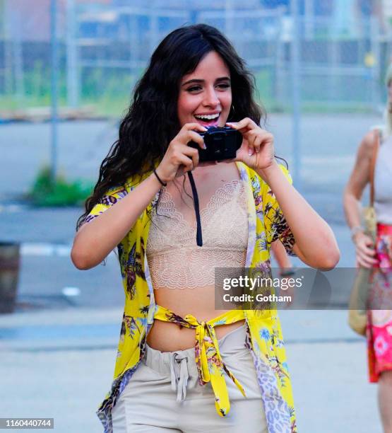 Camila Cabello takes a photo while out with Shawn Mendes on August 8, 2019 in New York City.