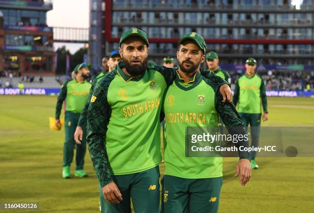Imran Tahir and JP Duminy of South Africa leave the field for the final time in International Cricket during the Group Stage match of the ICC Cricket...