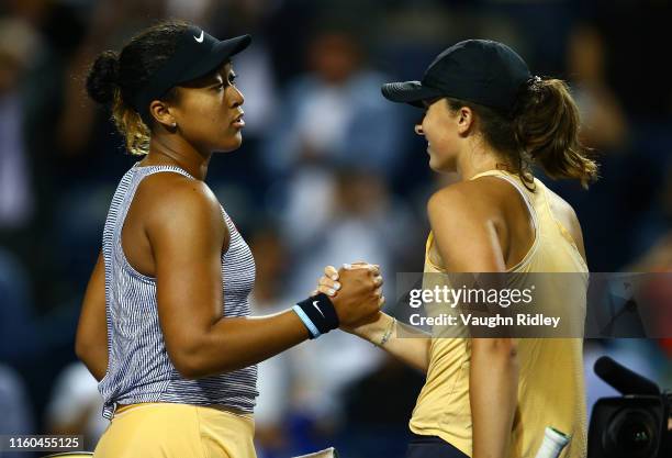 Naomi Osaka of Japan shakes hands with Iga Swiatek of Poland following a third round match on Day 6 of the Rogers Cup at Aviva Centre on August 08,...