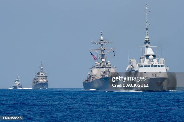 Photo taken on August 7 shows the French anti-submarine frigate FREMM Auvergne and the US Navy USS Donald Cook class guided missile destroyer and the...