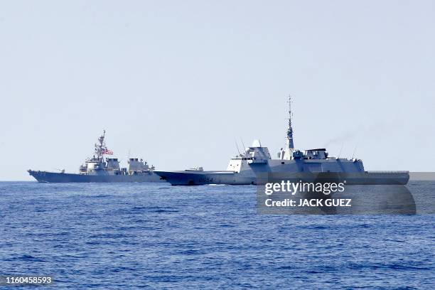 Photo taken on August 7 shows the US Navy USS Donald Cook class guided missile destroyer and the French anti-submarine frigate FREMM Auvergne during...