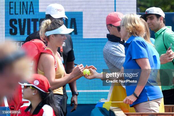 Elina Svitolina of Ukraine signs the ball for fans after the round 16 match of championship in the Rogers Cup tennis tournament at Aviva Centre on...
