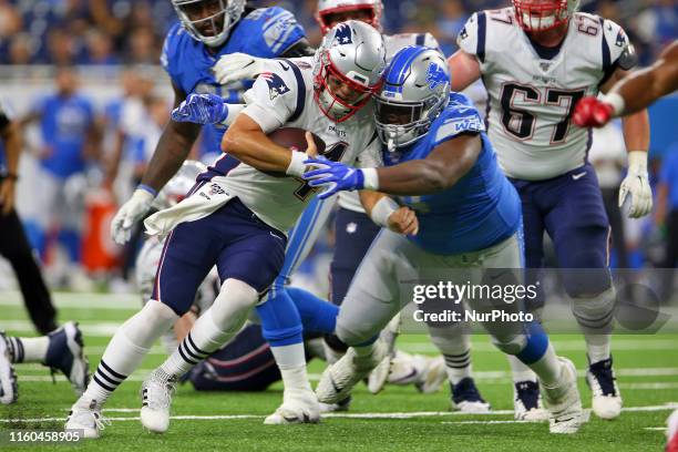 New England Patriots Jarrett Stidham is taken down by Detroit Lions Fred Jones during the second half of an NFL football game against the New England...