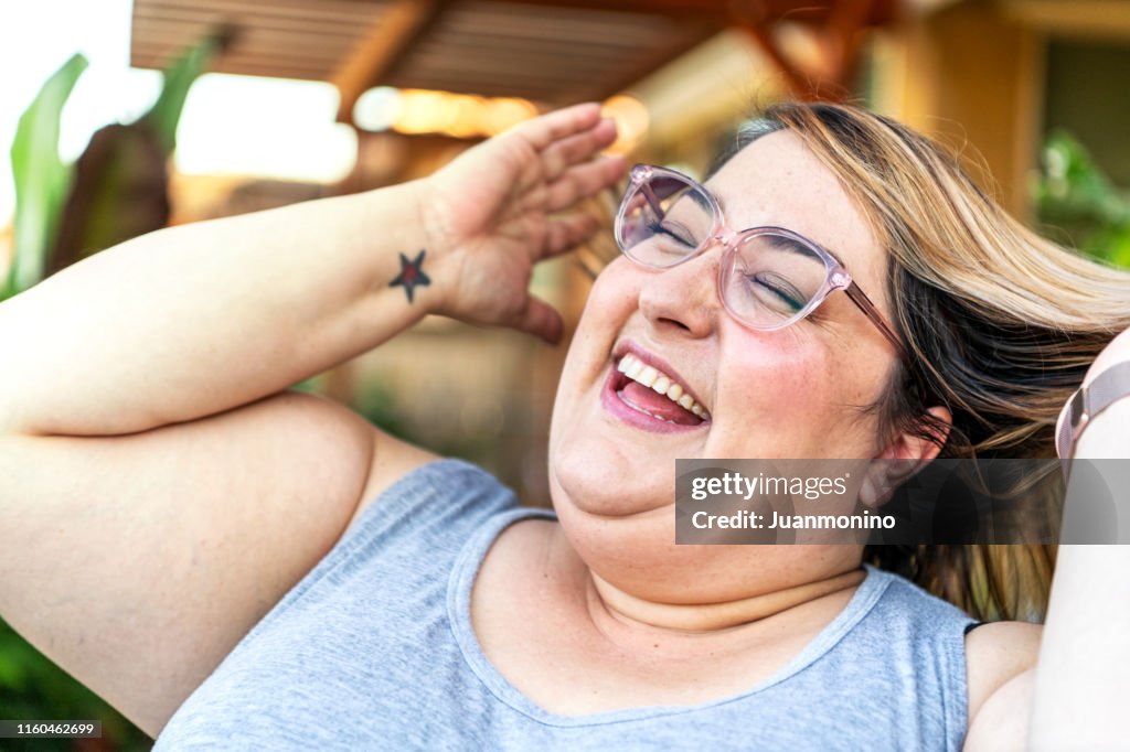 Mid adult woman laughing