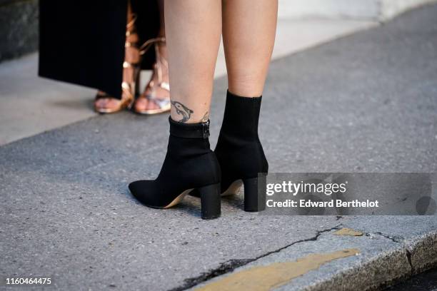 Guest wears black sock boots, outside the "Scandal A Paris" : Jean-Paul Gaultier's New Fragance Launch Dinner Party At Lassere on April 24, 2019 in...