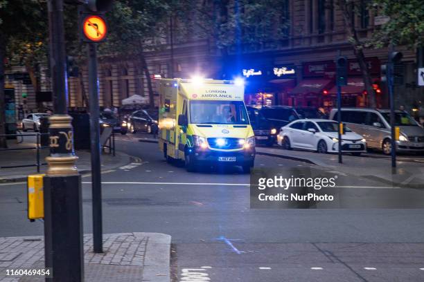 Ambulance London, an emergency vehicle from NHS Trust seen in motion with sirens near Trafalgar Square in the center of London, England, UK on August...