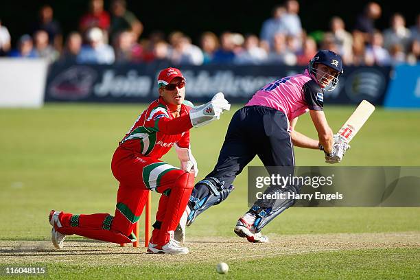 Ryan McLaren of Middlesex hits out watched by Mark Wallace of Glamorgan during the Friends Life T20 match between Middlesex and Glamorgan at Richmond...