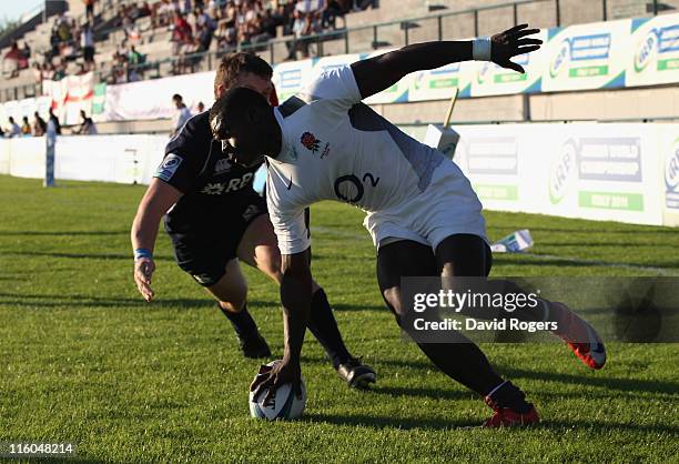 Christian Wade of England races clear to score his third try during the IRB Junior World Championship match between England and Scotland at the...