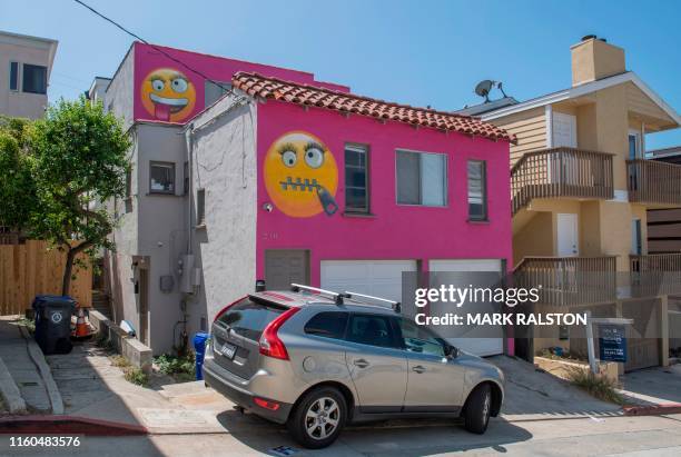 View of the pink emoji house that has become embroiled in a feud between neighbors in Manhatten Beach, California on August 9, 2019. - A house...