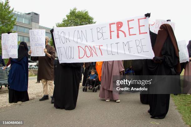 Muslim and non-muslim women stage a protest against the burqa ban, which was come into effect on August 1st, at Koekamp Square to raise awareness for...