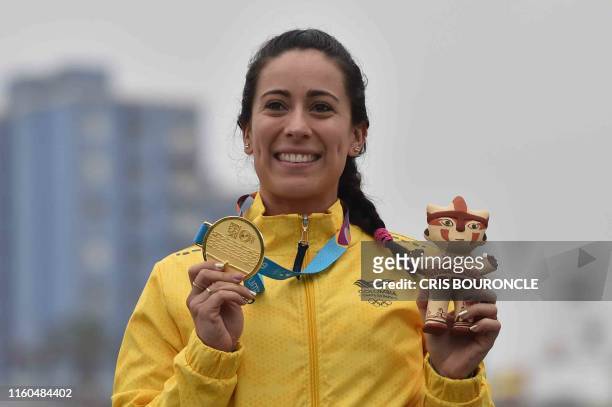 Colombia's Mariana Pajon celebrates after receiving the gold medal on the podium of the Women's BMX Race Final during the Lima 2019 Pan-American...