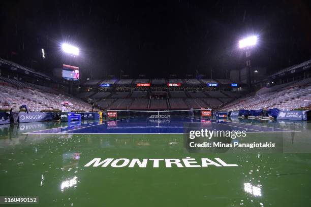 Rain delays play between Roberto Bautista Agut of Spain and Gael Monfils of France during day 8 of the Rogers Cup at IGA Stadium on August 9, 2019 in...