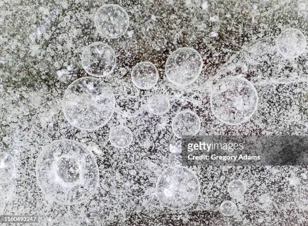 frozen bubbles in winter ice - permafrost stock-fotos und bilder