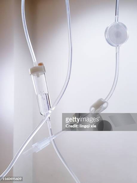 infusion set suspended in hospital ward - infused - fotografias e filmes do acervo