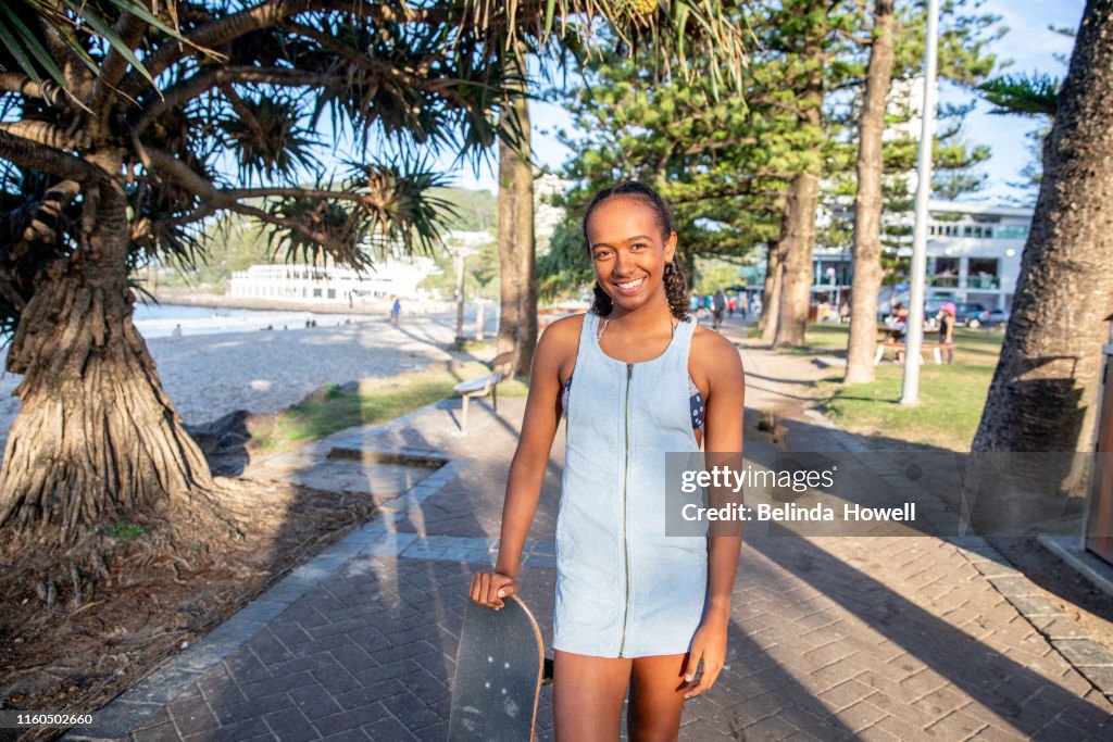 Aboriginal Australian Teenager walking through her city streets, with her mother, posing.