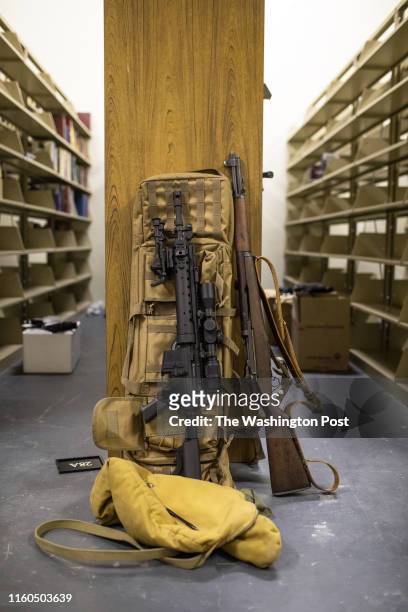 Pair of rifles lean against a bookshelf at the Defense Distributed library, located behind the company's factory, in Austin, Texas, on Aug. 5, 2018.
