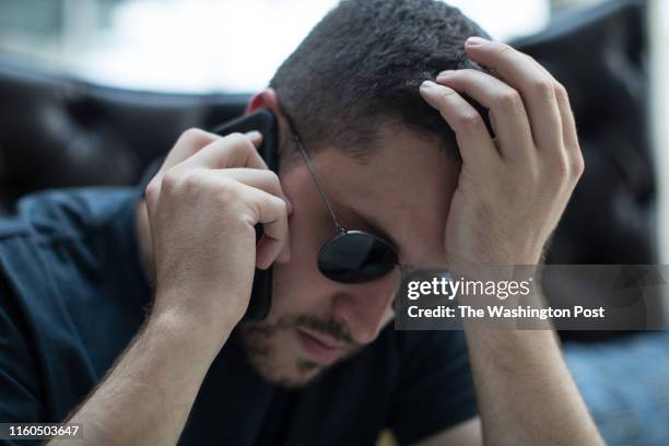 Cody Wilson, director of Defense Distributed, makes a phone call while sitting down for lunch at a restaurant in Austin, Texas, on Aug. 5, 2018.