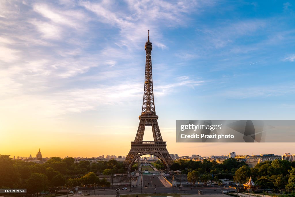 Landscape panoramic view on the Eiffel tower during the sunrise in Paris, France. Romantic travel background.