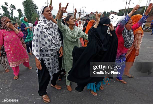 Kashmiri women shout pro freedom slogans as they run for safer places after Indian forces fire teargas shells on people who were protesting against...