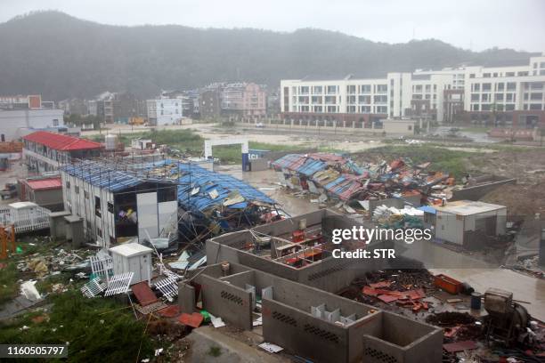 Damaged worker accommodation buildings are seen at a construction site in Wenling City, in China's eastern Zhejiang province after being hit by...