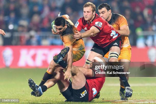 Jeronimo de la Fuente of the Jaguares is tackled by Owen Franks of the Crusaders and Mitchell Dunshea of the Crusaders during the Super Rugby Final...