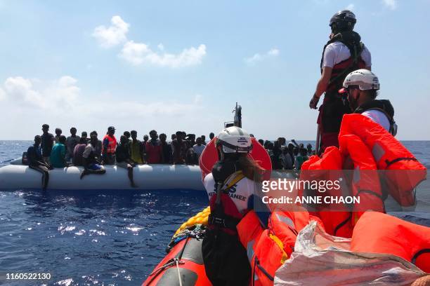Crew members of the 'Ocean Viking' rescue ship, operated by French NGOs SOS Mediterranee and Medecins sans Frontieres , stand ready on board of a...