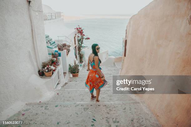 young beautiful woman exploring santorini,greece - mediterranean tour stock pictures, royalty-free photos & images