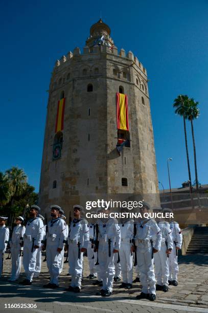 Sailors stand to attention next to the Torre del Oro - Maritime Museum of Seville during the celebrations marking the 500th anniversary of Ferdinand...
