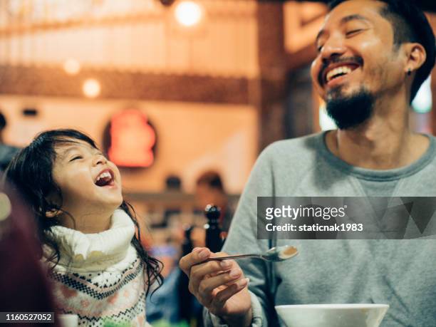 asian hipster father eating korean barbecue buffet with his daughter in the restaurant. - korean chopsticks stock pictures, royalty-free photos & images