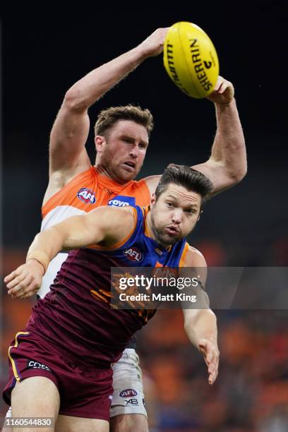 Stefan Martin of the Lions is challenged by Dawson Simpson of the Giants during the round 16 AFL match between the Greater Western Sydney Giants and...