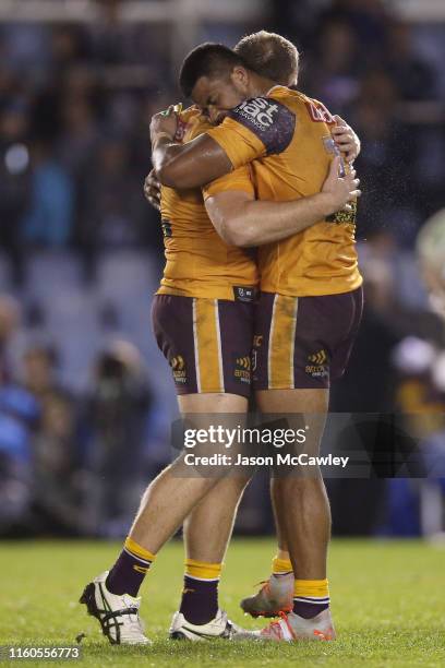 Payne Haas of the Broncos embraces Matthew Lodge of the Broncos after victory during the round 16 NRL match between the Cronulla Sharks and the...