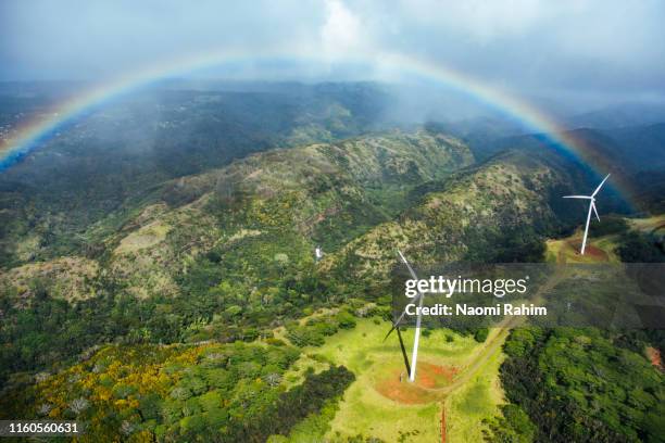 aerial view of a rainbow over two windmills in a lush valley - oahu, hawaii - hawaii islands overhead stock pictures, royalty-free photos & images