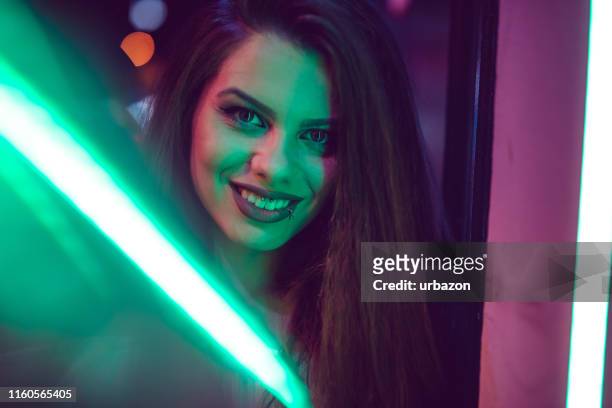 woman and neon light - neon lighting smiling stock pictures, royalty-free photos & images